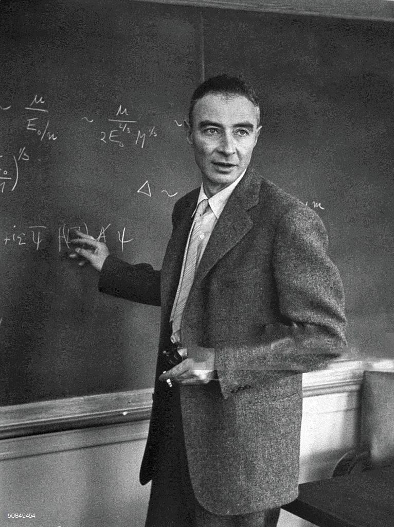 J. Robert Oppenheimer working out physics equations on the blackboard